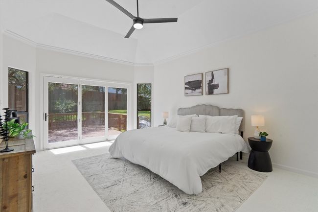 Bedroom featuring carpet, access to outside, a high ceiling, and ceiling fan | Image 17