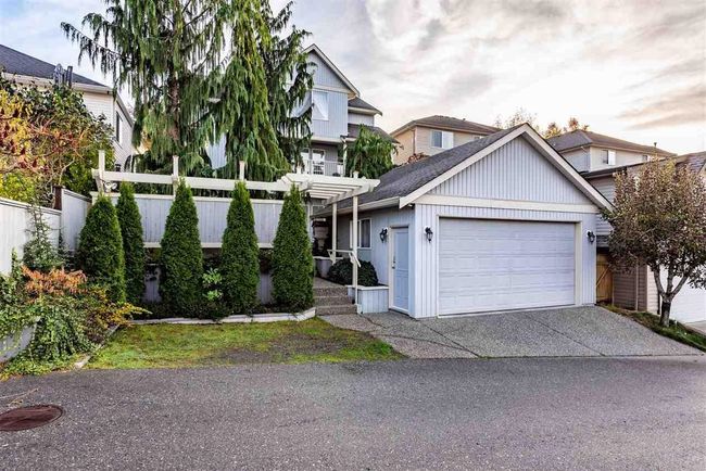 View of front of house with driveway, a garage, and fence | Image 6
