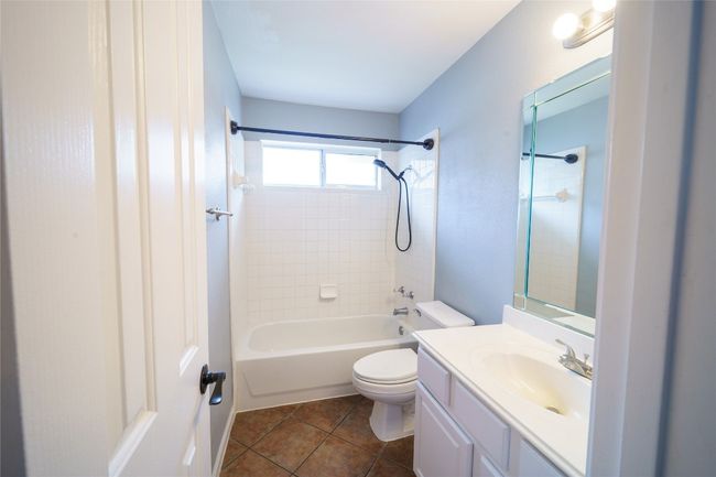 Bathroom featuring toilet, vanity, washtub / shower combination, and tile patterned flooring | Image 27