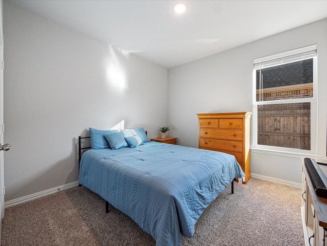 Bedroom with baseboards and dark carpet | Image 18