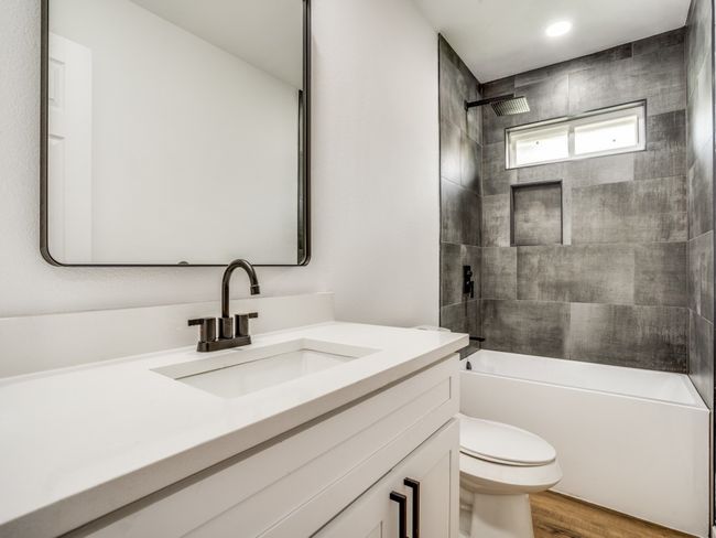 Full bathroom featuring toilet, vanity, shower / bath combination, wood finished floors, and recessed lighting | Image 14