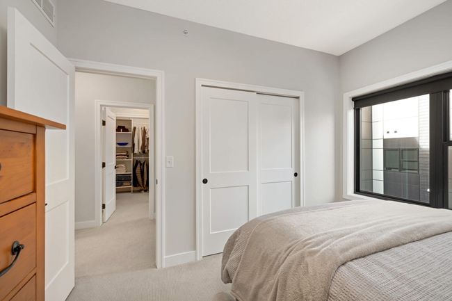 Sliding paneled closet doors and easy access to full bathroom | Image 19