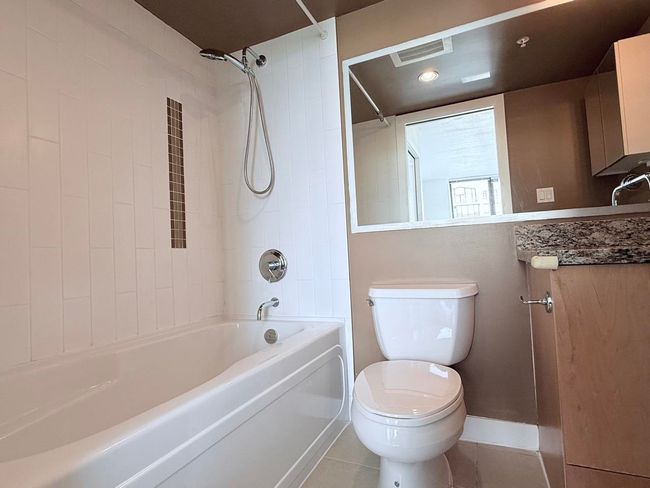 Bathroom featuring shower / bathtub combination, vanity, and tile patterned floors | Image 18