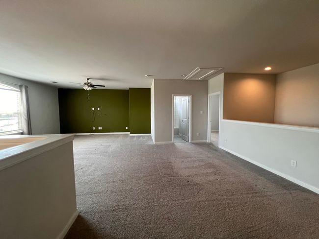 Carpeted empty room featuring attic access, a ceiling fan, and recessed lighting | Image 23