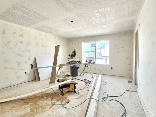 Exercise area featuring a textured ceiling | Image 25