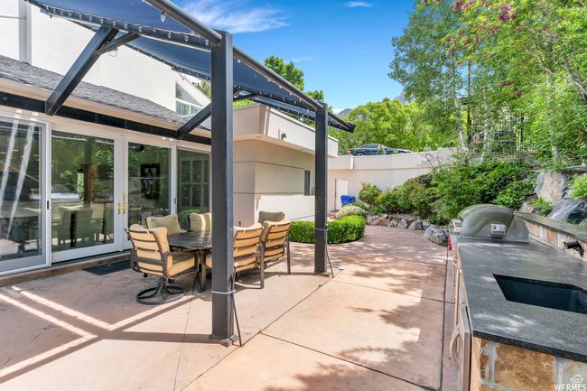 View of patio featuring a lanai, outdoor dining space, and exterior kitchen | Image 98