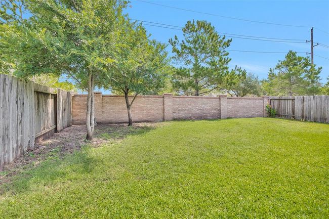 The spacious backyard offers plenty of room to relax, play, or entertain—complete with the added bonus of no rear neighbors for extra privacy and tranquility. | Image 24