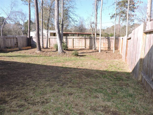 The large backyard is fenced | Image 29