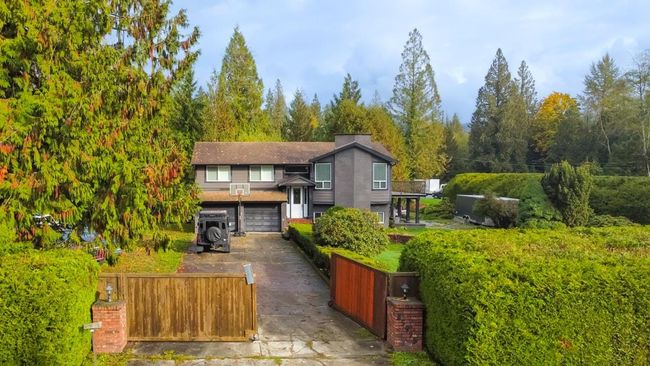 View of front of house with driveway, a garage, and a fenced front yard | Image 32