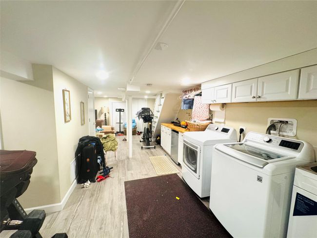 Laundry area featuring separate washer and dryer, baseboards, light wood-style floors, and laundry area | Image 16