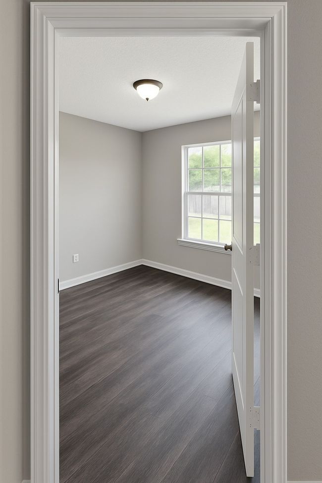 Empty room with dark wood-style floors and baseboards | Image 9