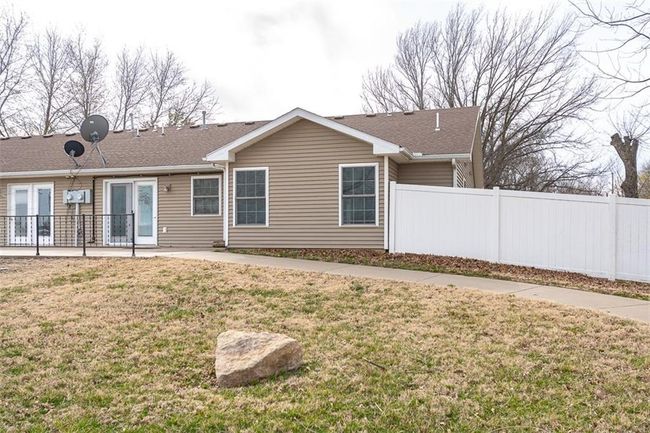 Rear view of house with a yard, a patio, and fence | Image 34