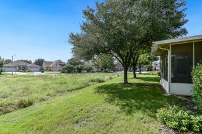 View of grassy yard with a sunroom | Image 10