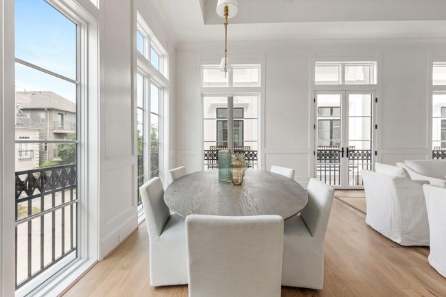 The whole of the expansive living area is lined large windows as well as a set of French doors which open to the Juliet balcony featuring intricate iron detailing. | Image 7