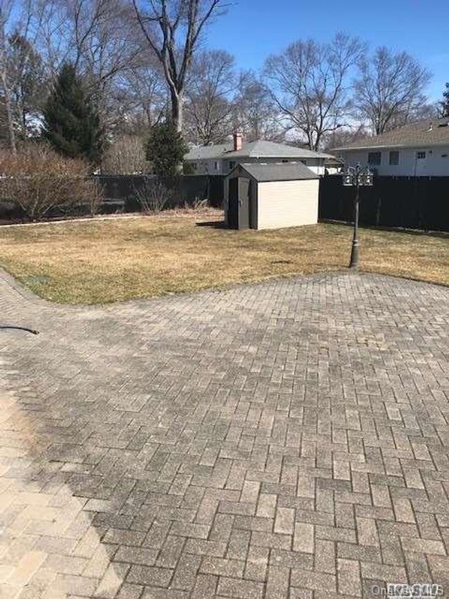 View of patio with fence, a shed | Image 18