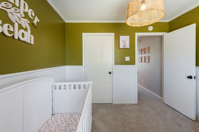 Bedroom featuring wainscoting, carpet flooring, and crown molding | Image 14