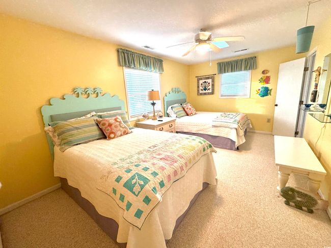 Carpeted bedroom with ceiling fan and a textured ceiling | Image 31
