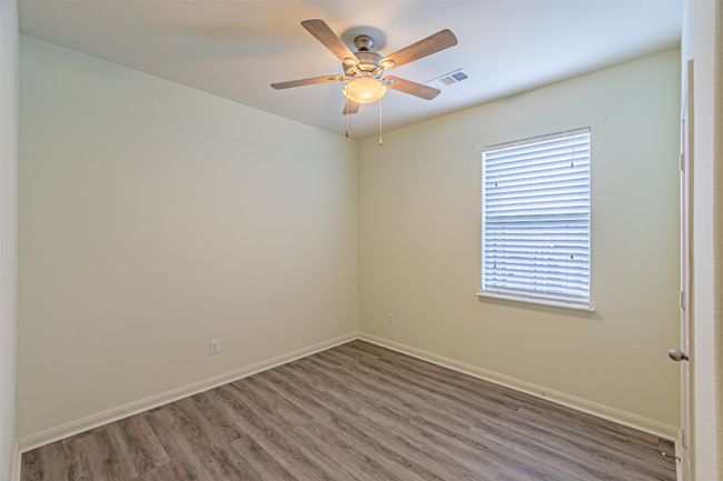 Spare room featuring wood finished floors, ceiling fan, and baseboards | Image 23