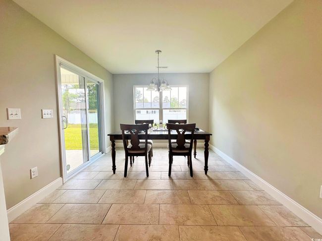 Dining area featuring baseboards and a notable chandelier | Image 6