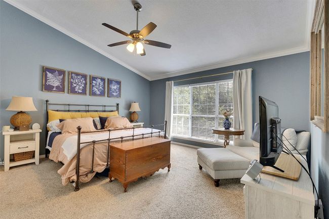 Carpeted bedroom featuring lofted ceiling, crown molding, and a ceiling fan | Image 20