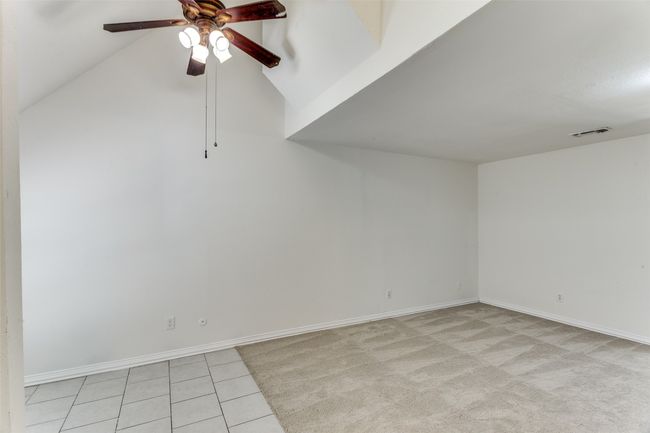 Spare room featuring ceiling fan and light tile patterned flooring | Image 6