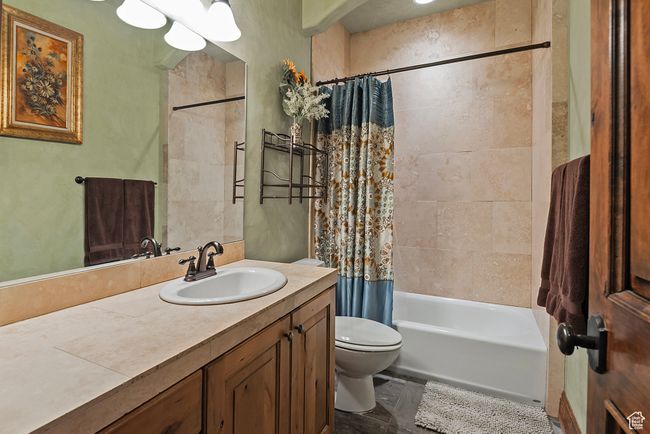 Full bath featuring toilet, shower / bath combo with shower curtain, and vanity | Image 40