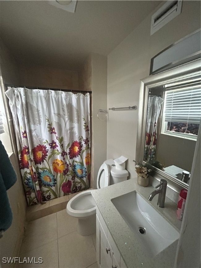 Full bath with vanity, tile patterned flooring, and curtained shower | Image 7