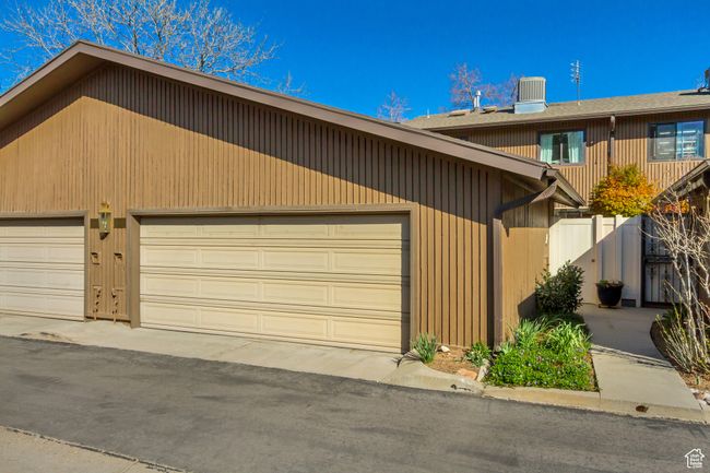 View of front of home with central AC, fence, and a garage | Image 29