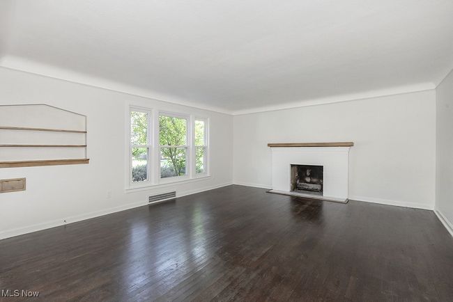 Unfurnished living room with dark hardwood / wood-style floors | Image 9