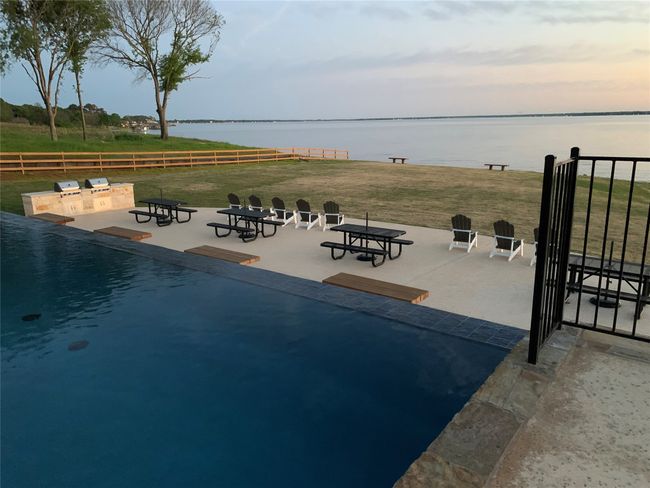 View of swimming pool with a water view and a patio | Image 4