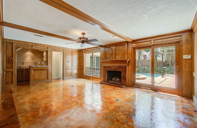 Fireplace and wet bar in the main living area. | Image 11