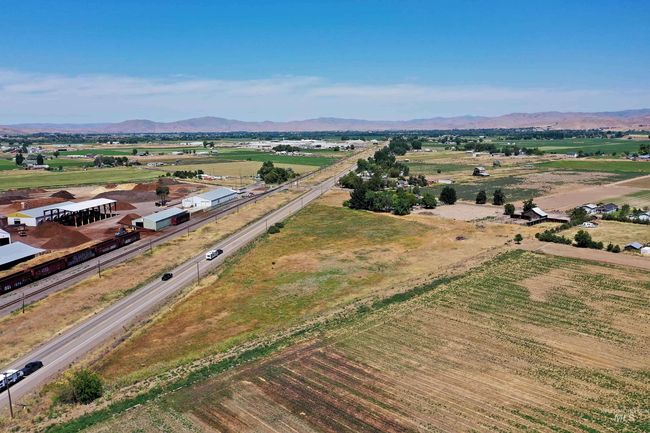 Aerial view of sparsely populated area featuring a mountainous background | Image 6
