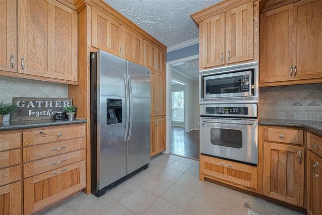 The kitchen is spacious and open. | Image 11