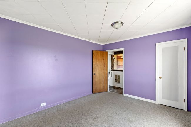 Unfurnished bedroom with ornamental molding, carpet, and baseboards | Image 26