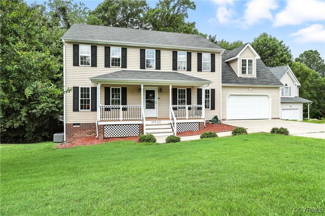 Colonial house with a porch, driveway, a front yard, an attached 2-Car garage | Image 31