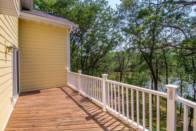 The deck is on the back of the house and overlooks the lake and private backyard. Enjoy a summer barbeque or your morning coffee with only the peaceful sound of nature in your backyard. | Image 36