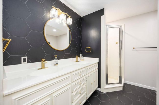 Well-maintained primary bathroom featuring stylish fixtures, a separate shower, and a bathtub for added convenience. | Image 28