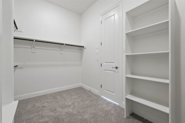Spacious closet with carpet flooring | Image 23