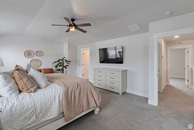 Carpeted bedroom featuring lofted ceiling, baseboards, and a ceiling fan | Image 13