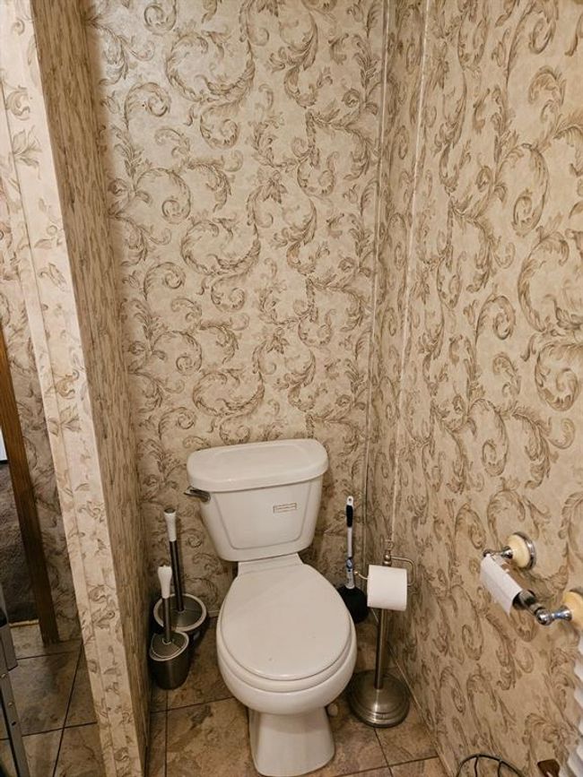 Bathroom with toilet and tile patterned flooring | Image 36