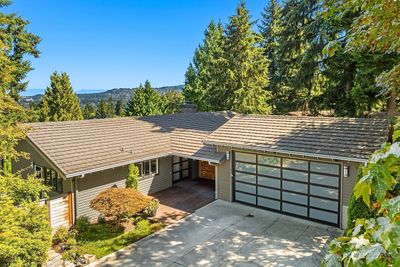 Welcome to 9336 Mercerwood Drive, a mid-century modern gem distinguished by sweeping Cascade mountain views and inspiring contemporary design, set in the coveted Mercerwood neighborhood on the north end of Mercer Island. | Image 1