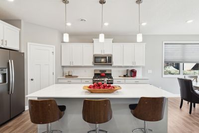 (Photo of decorated model, finishes will vary) Enjoy plenty of seating at the kitchen island and dining area adjacent to the kitchen. | Image 2