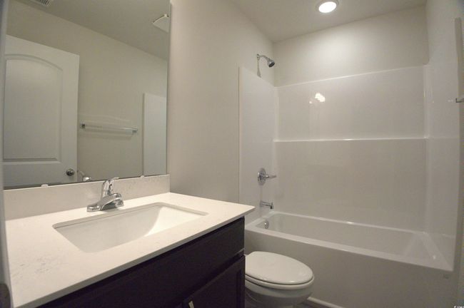 Bathroom with tub / shower combination, vanity, and recessed lighting | Image 5