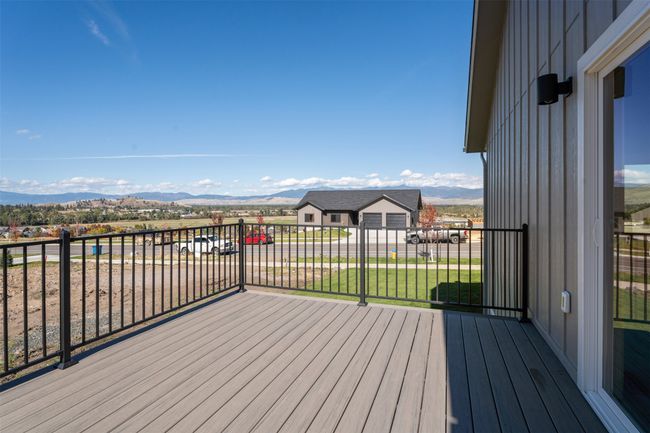 Wooden deck featuring a mountain view and a yard | Image 10