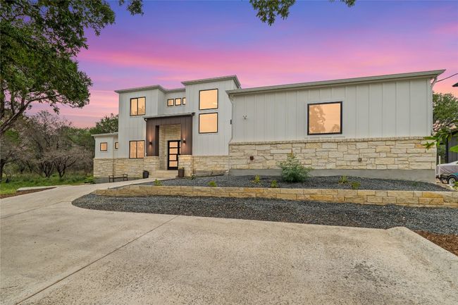 Contemporary house with stone siding and board and batten siding | Image 40