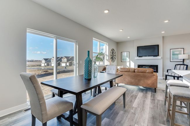 Natural light pours through the large windows. Photo is of a previously built model home, finishes and selections will vary. | Image 9
