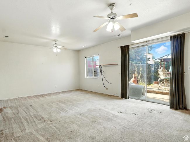 Empty room featuring a ceiling fan and carpet floors | Image 9