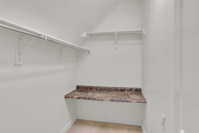 Spacious closet featuring lofted ceiling | Image 30