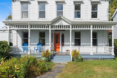 View of front of home with a front yard and covered porch | Image 2