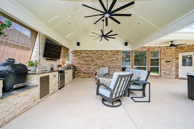 A large covered back patio, offering a versatile outdoor space that can be enjoyed in various weather conditions. | Image 41